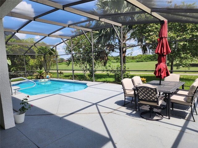 view of swimming pool with a patio and glass enclosure