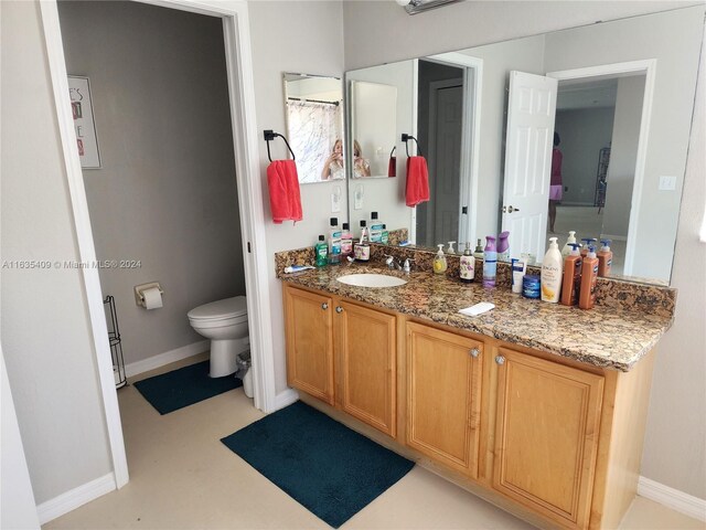 bathroom featuring toilet and vanity