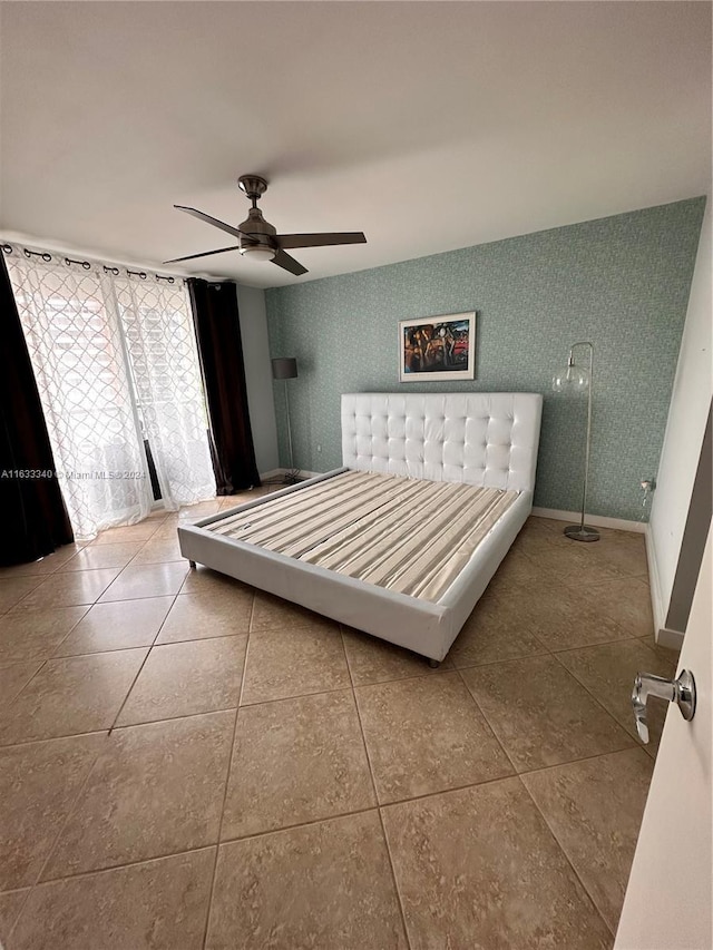 bedroom with ceiling fan and tile patterned floors