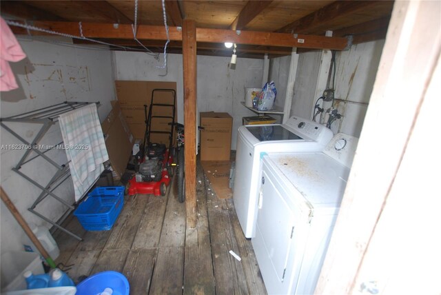 laundry area featuring washer and clothes dryer and wood-type flooring