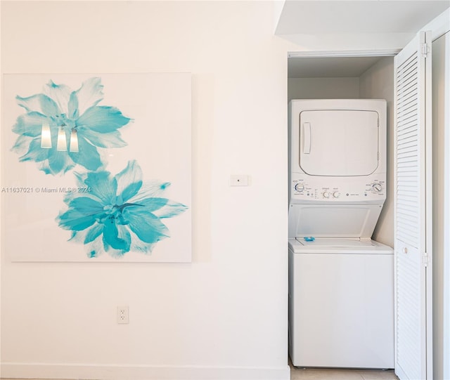 clothes washing area with stacked washer / dryer