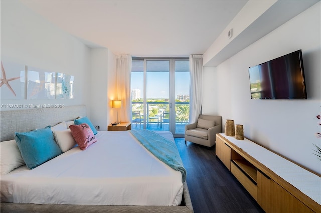 bedroom featuring dark hardwood / wood-style flooring, expansive windows, and access to exterior