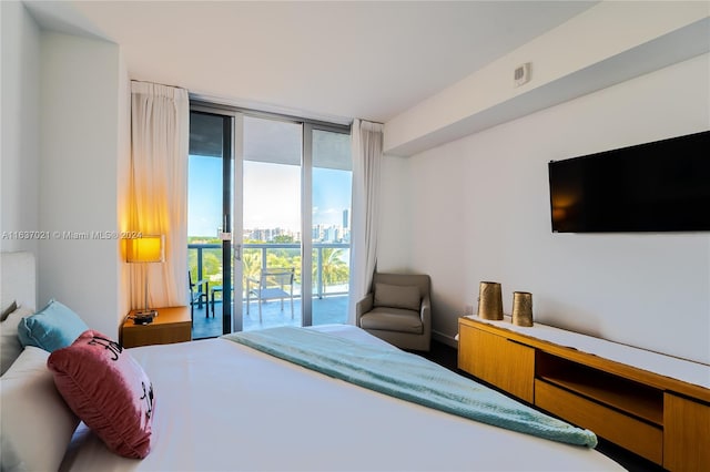 bedroom featuring access to exterior and floor to ceiling windows