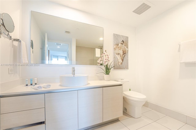 bathroom featuring vanity, tile patterned flooring, and toilet