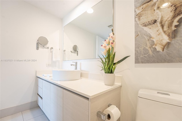 bathroom featuring tile patterned floors, toilet, and vanity