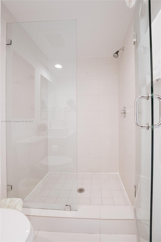 bathroom with an enclosed shower and toilet