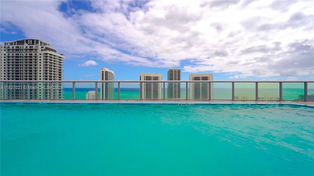 view of swimming pool with a water view