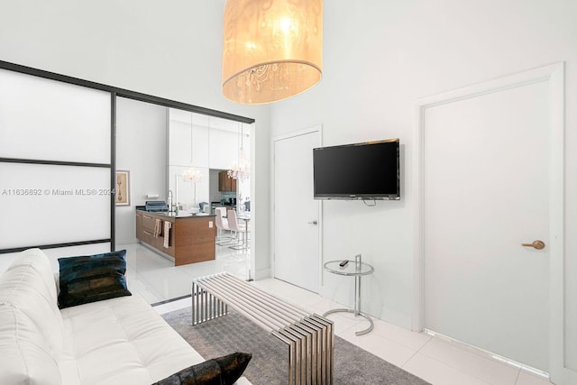 living room featuring light tile patterned flooring and a towering ceiling