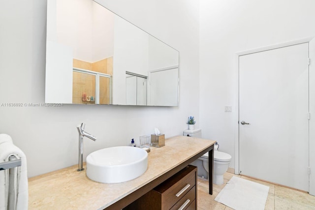 bathroom featuring toilet, vanity, and tile patterned flooring