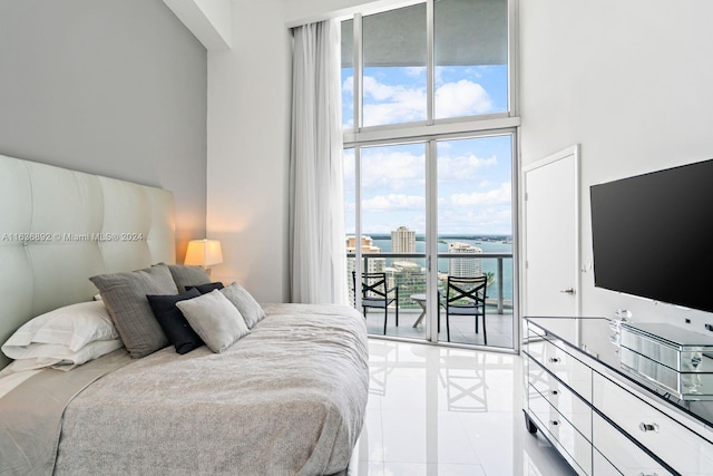 tiled bedroom with access to exterior and a high ceiling