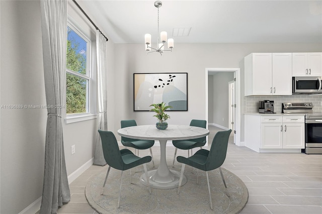 dining area with an inviting chandelier and light tile patterned floors