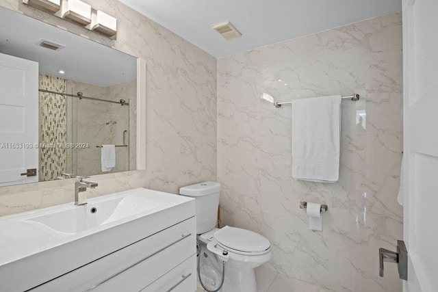 bathroom featuring vanity, toilet, tile walls, and tiled shower