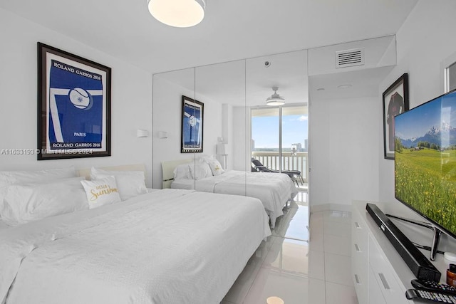 bedroom with access to outside and light tile patterned floors