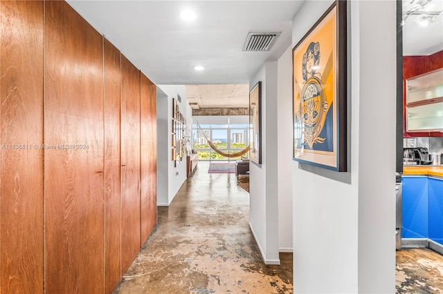 corridor featuring concrete flooring