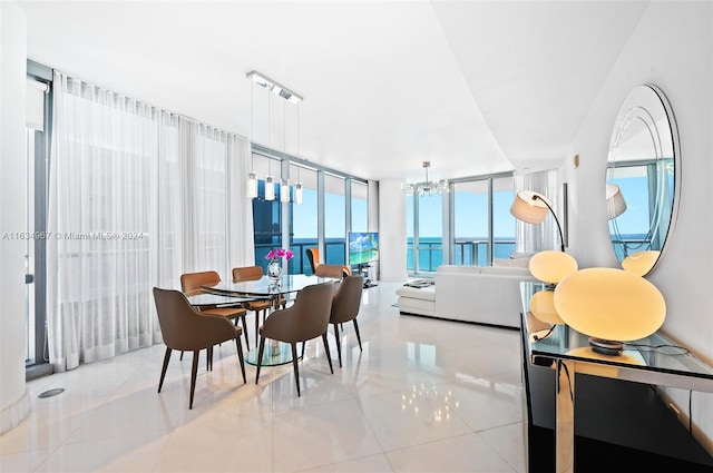 dining area featuring tile patterned flooring, expansive windows, and a chandelier