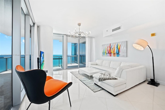 tiled living room with a notable chandelier, a wall of windows, and a water view