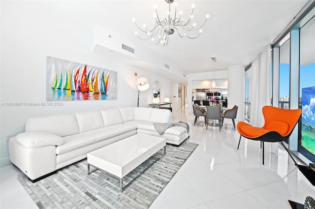 living room featuring light tile patterned flooring, a notable chandelier, and a wall of windows