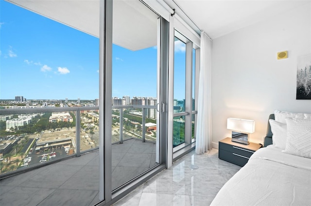 bedroom featuring a city view, expansive windows, and marble finish floor