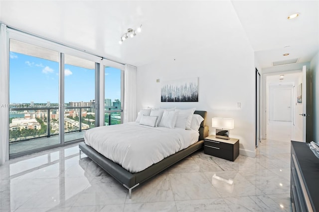 tiled bedroom with expansive windows and access to exterior