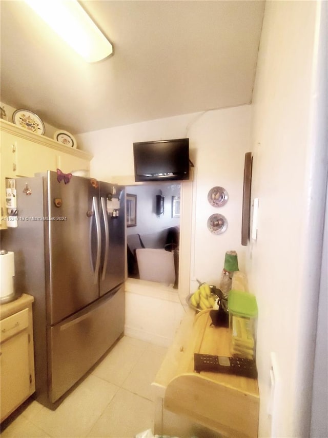 kitchen with stainless steel refrigerator and light tile patterned floors