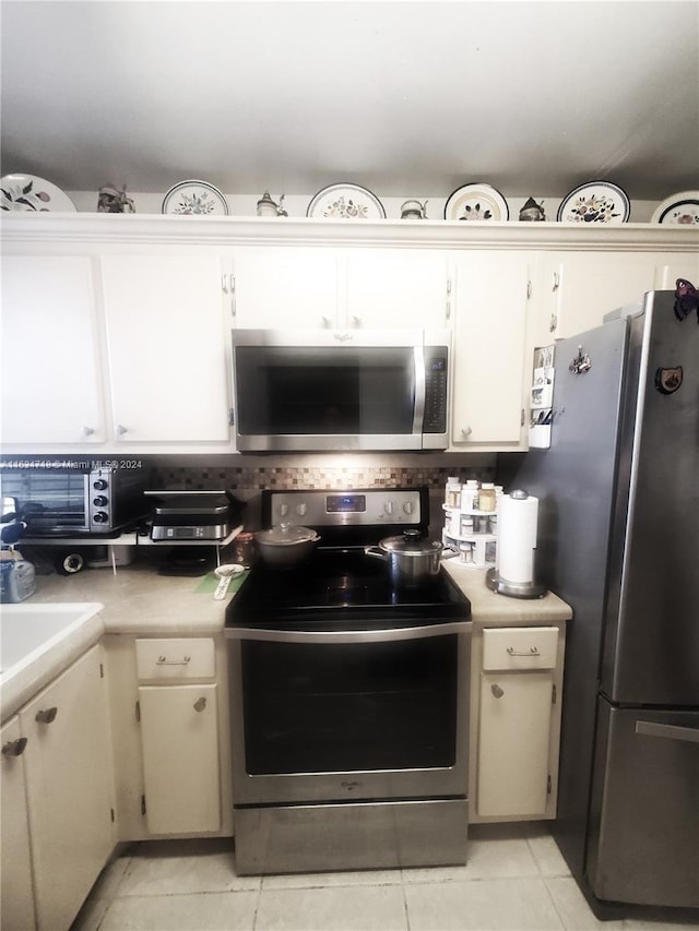 kitchen featuring appliances with stainless steel finishes and light tile patterned floors