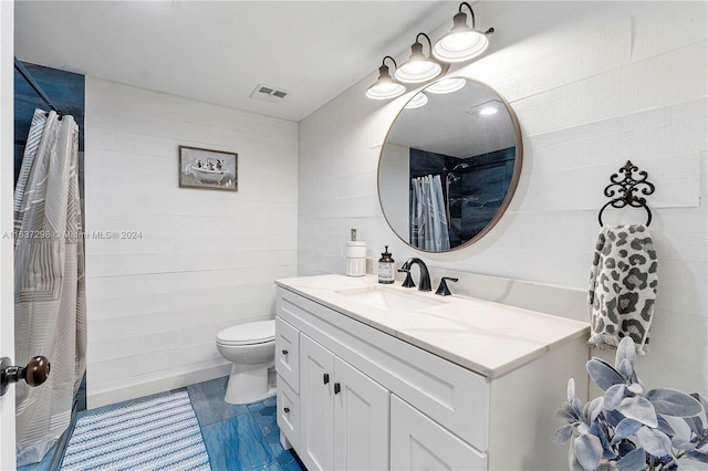 bathroom featuring tile patterned floors, toilet, and vanity