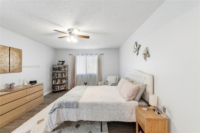 bedroom featuring a textured ceiling, ceiling fan, and dark hardwood / wood-style floors