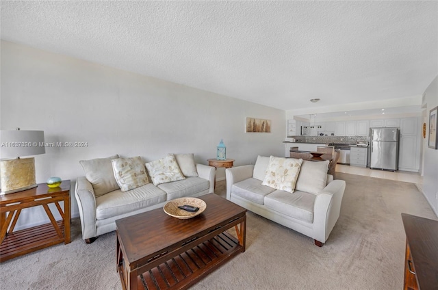 carpeted living room with a textured ceiling