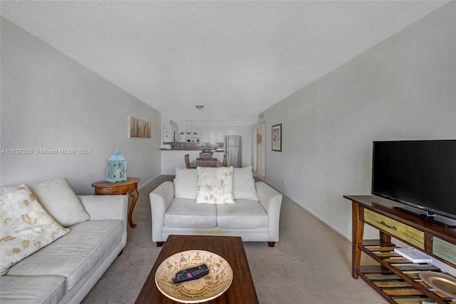 carpeted living room featuring a textured ceiling