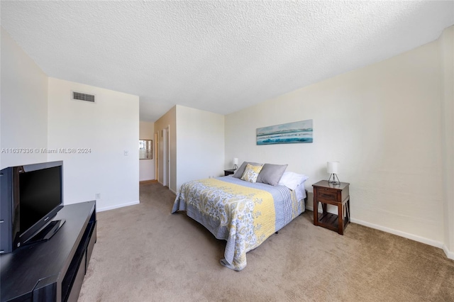 carpeted bedroom featuring a textured ceiling