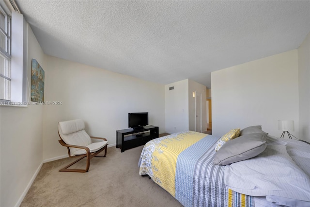 bedroom featuring a textured ceiling and carpet floors