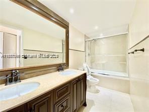 full bathroom with shower / bathtub combination, dual vanity, toilet, and tile patterned floors