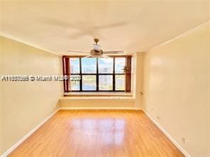 spare room featuring ceiling fan and light hardwood / wood-style floors