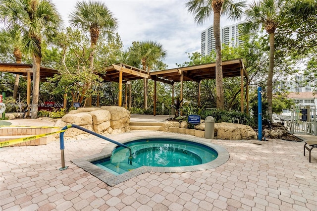 view of pool with a pergola, a patio area, and a hot tub