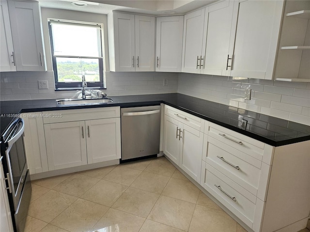 kitchen with white cabinetry, stove, light tile patterned flooring, dishwasher, and sink