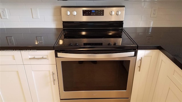 kitchen featuring white cabinetry, stainless steel electric stove, and backsplash