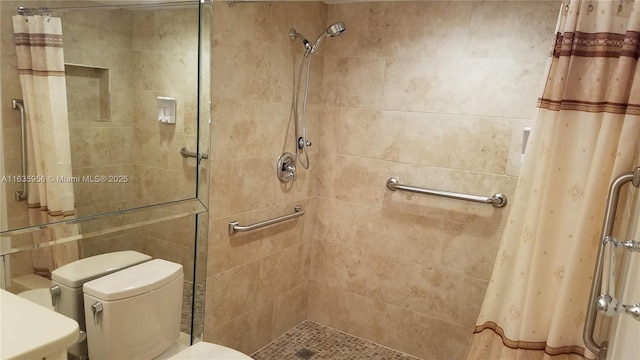 bathroom with toilet and a shower with shower curtain