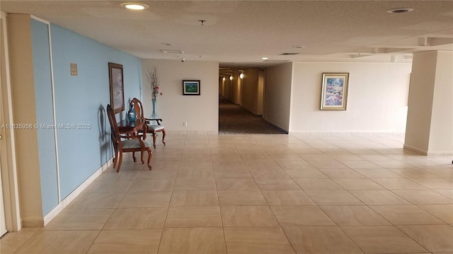 hall featuring light tile patterned floors