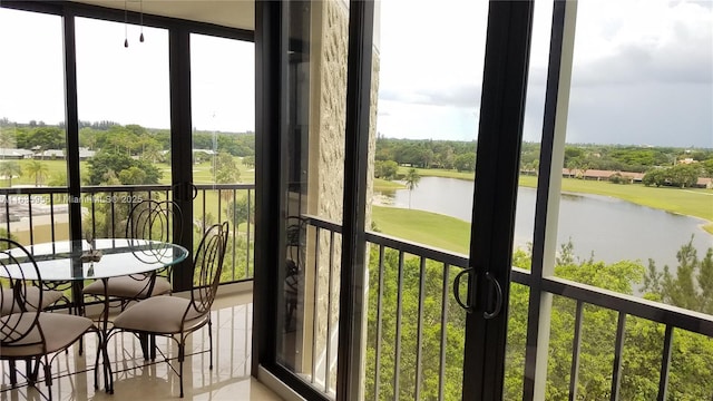 sunroom featuring a water view and plenty of natural light