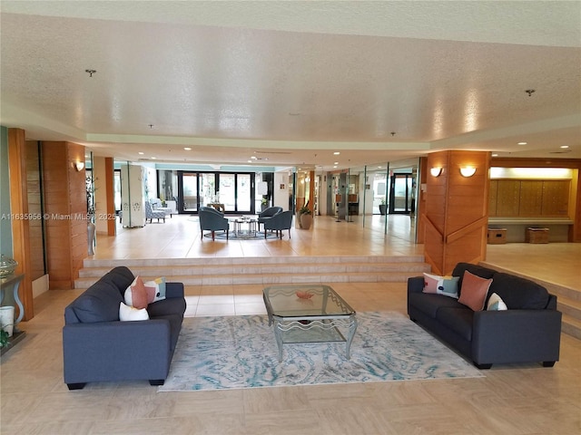 living room with light tile patterned floors and a textured ceiling