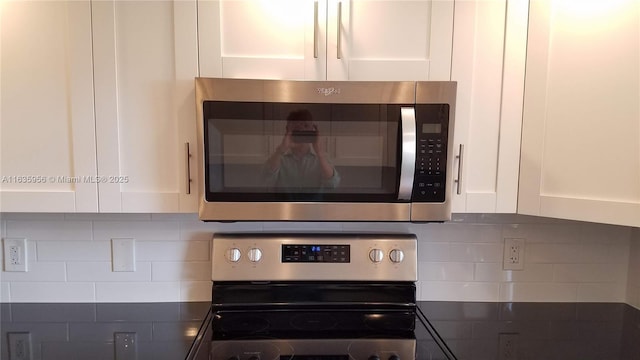 details with decorative backsplash, stainless steel appliances, and white cabinetry