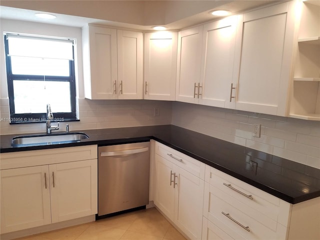 kitchen with dishwasher, white cabinetry, sink, backsplash, and light tile patterned floors