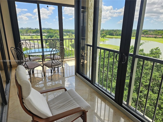 sunroom with a water view and a healthy amount of sunlight