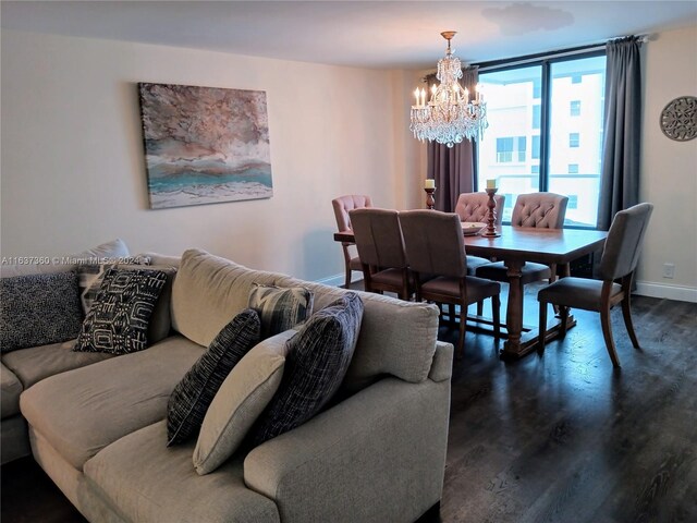 living room with a chandelier and dark hardwood / wood-style floors