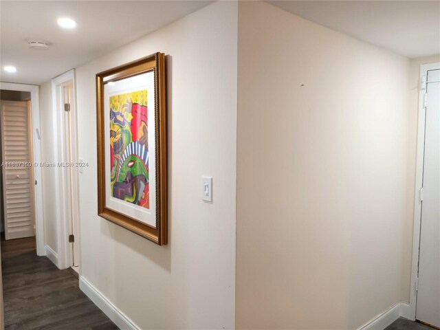 corridor with dark hardwood / wood-style flooring