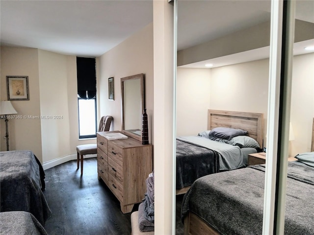 bedroom with dark hardwood / wood-style floors