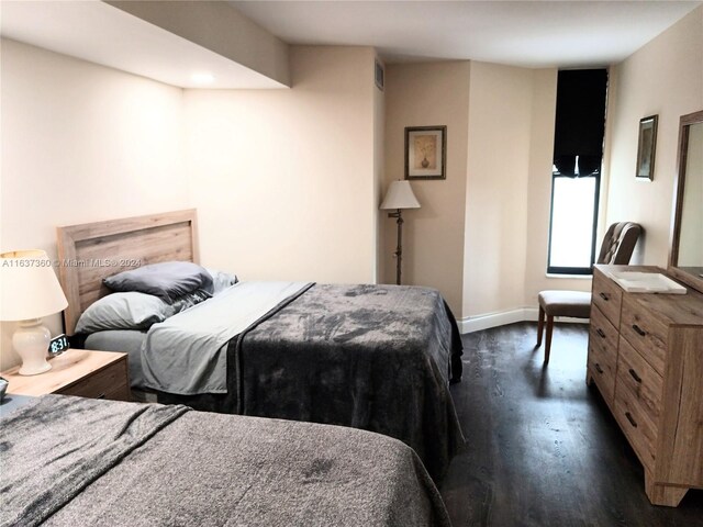 bedroom featuring dark hardwood / wood-style flooring