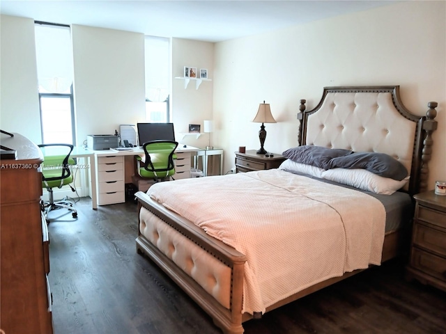 bedroom with dark hardwood / wood-style flooring