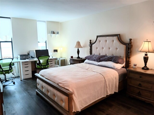 bedroom with dark hardwood / wood-style floors