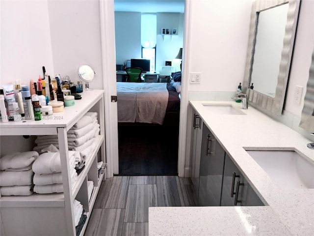 bathroom featuring dual vanity and wood-type flooring